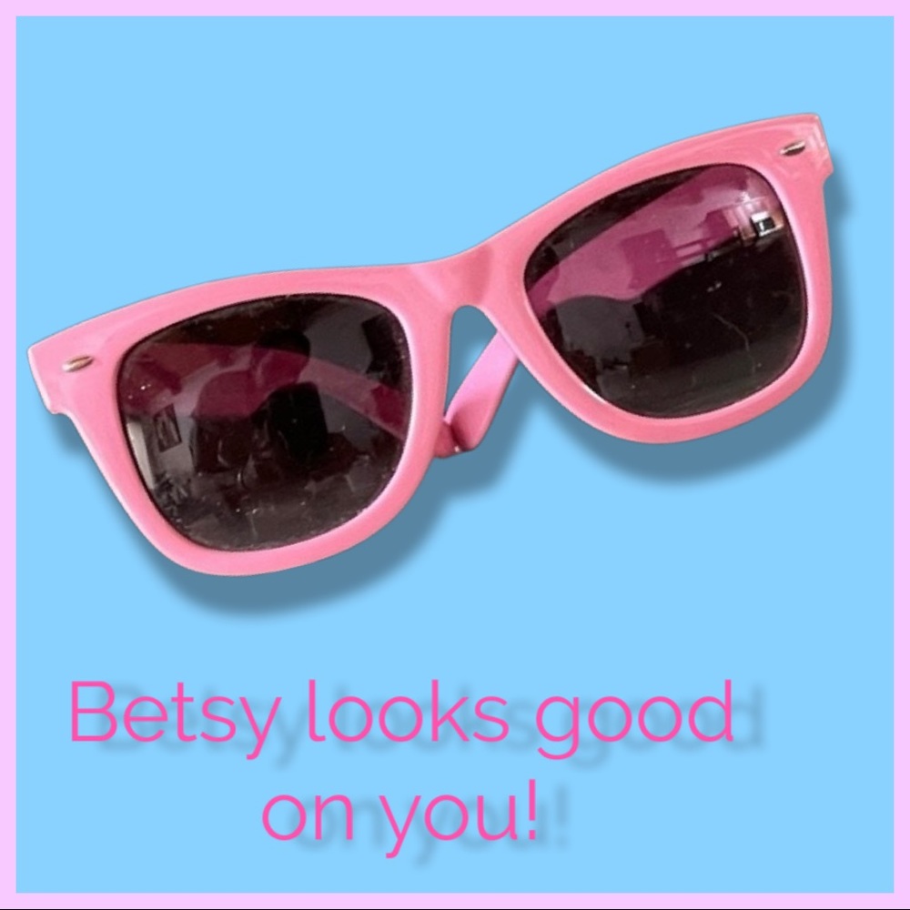 BETSEY JOHNSON Sunglasses. Pink frame with brown lenses.